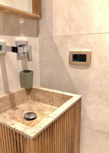 a bathroom with a sink with a faucet at Boulevard Exclusive in Pristina