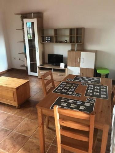 eine Küche mit einem Tisch und Stühlen sowie eine Küche mit einem Kühlschrank in der Unterkunft Calle Montaña Aguarijo in Mocanal