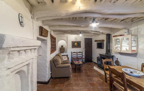 a living room with a couch and a fireplace at Casa Nicolasa in Capileira