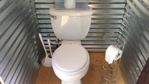 a bathroom with a white toilet in a room at Tipi in Monticello