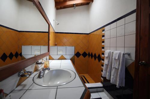 a bathroom with a sink and towels in it at Tierra Magica B&B and Art Studio in San José