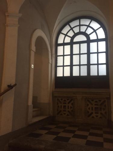a room with a large window and a checkered floor at Ai Tre Mercati in Palermo