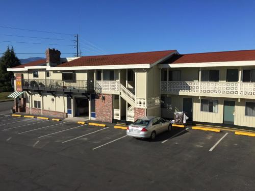 a car parked in a parking lot in front of a building at Port Angeles Inn in Port Angeles