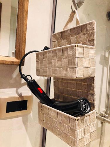 a pair of wicker baskets with a cord plugged in at Boulevard Exclusive in Pristina