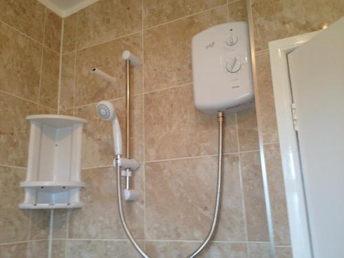 a shower with a hair dryer in a bathroom at 313 Sundowner Holiday Park Hemsby in Hemsby