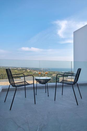 two chairs and a table on top of a roof at Elea Silver Villa in Peyia