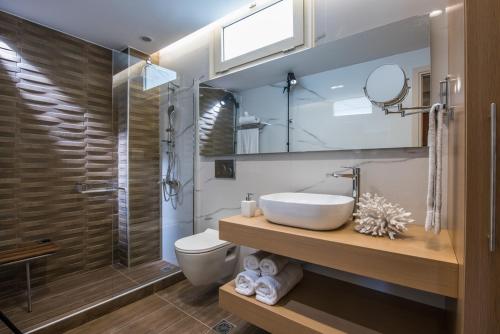 a bathroom with a sink and a toilet and a shower at Sonia Center II in Hersonissos