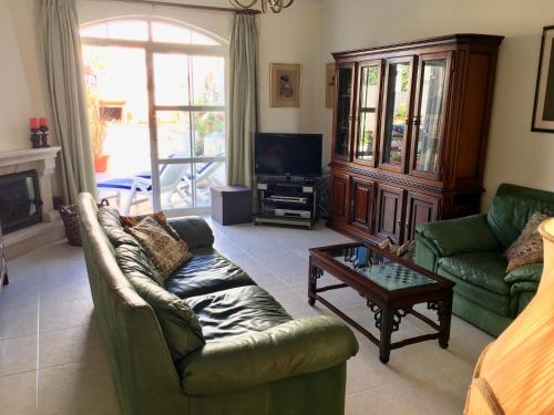a living room with a couch and a coffee table at Lagos Beach Villa in Lagos