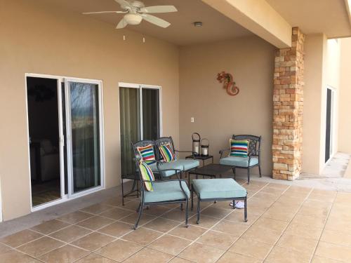 a patio with chairs and a table and a ceiling fan at Casa Tu Paz in La Paz