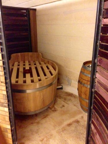 a room with a large wooden tub and a barrel at Masseria Ancella in Montalbano