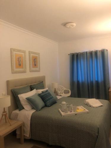 a bedroom with a bed with a tray on it at Beach Apartment Vilamoura Villa Columbus in Vilamoura