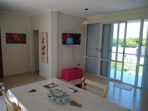 a dining room with a table with a plate on it at JUANA II in Villa Elisa