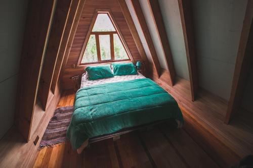 a small bed in a room with a window at Puente Palos San Pedro in Castro