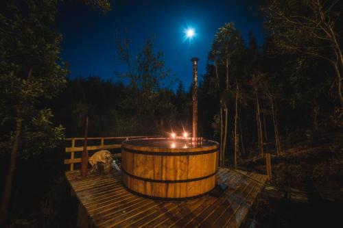 a wooden barrel with candles on a deck at night at Puente Palos San Pedro in Castro