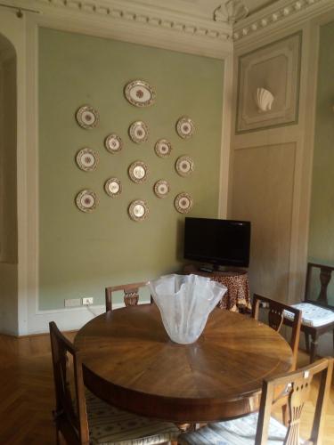 a dining room with a table and plates on the wall at B&B Palazzo Bianchi in Parma