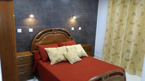a bedroom with a bed with a red comforter at Vista Atlântico in Gaula
