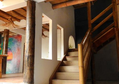 a staircase in a house with wooden beams at La Facha Hostal Restaurant Surf in Mompiche