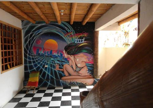 a painting of a woman on a wall in a room at La Facha Hostal Restaurant Surf in Mompiche