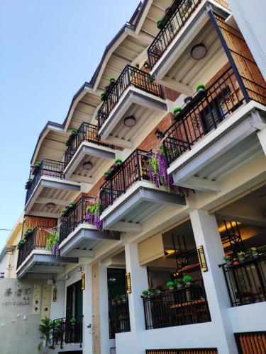 a building with balconies on the side of it at Teacher Cai Homeestay in Xiaoliuqiu