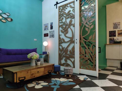 a living room with a couch and a door at Teacher Cai Homeestay in Xiaoliuqiu