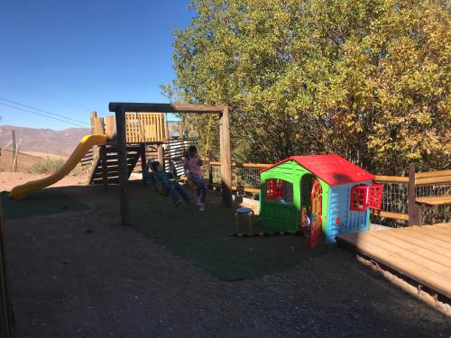 a child playing on a playground with a slide at Hotel HF in Farellones