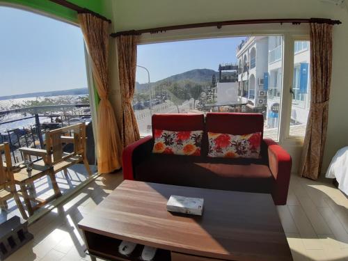 a living room with a couch and a large window at Hearty Homestay in Nanwan