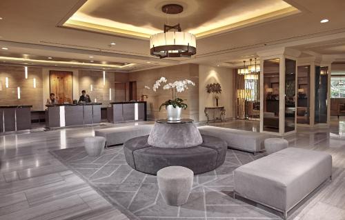 a lobby with a table and chairs in a building at Quest Plus Conference Center, Clark in Clark