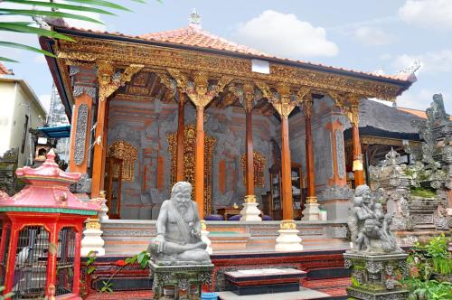 a building with a statue in front of it at Nick's Homestay in Ubud