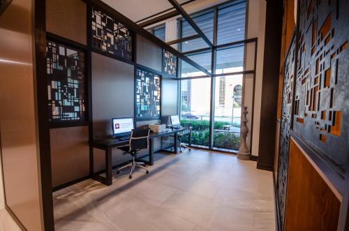 an office with a desk and a computer on a wall at Texas A&M Hotel and Conference Center in College Station