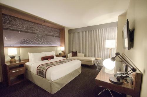 a hotel room with a large bed and a couch at Texas A&M Hotel and Conference Center in College Station