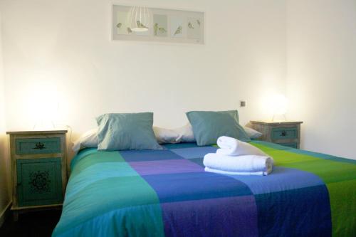 a bedroom with a rainbow bed with two night stands at Casa Piedra Libre in Manzanares el Real