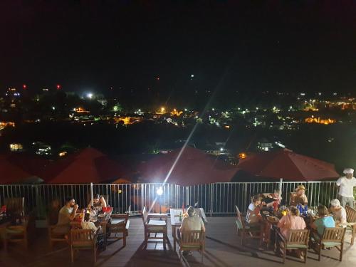 a group of people sitting on a deck at night at The Ridge Residence in Victoria