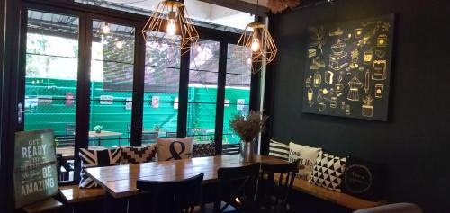 a dining room with a wooden table and a view of a baseball game at THE WOOD BOUTIQUE HOTEL in Muar