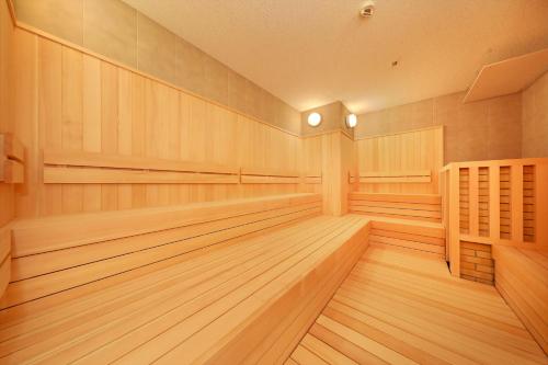 a sauna with wood paneling and lights on the walls at Hakone Kowakien Tenyu in Hakone