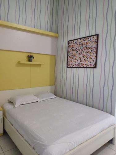Postel nebo postele na pokoji v ubytování Hotel Boegenviel Syariah