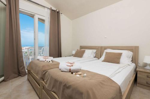 a bedroom with two beds with stuffed animals on them at Maria's Sea View Villa in Skala Rachoniou