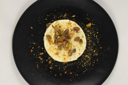 a plate of food with nuts on top of it at Central Hotel Boutique in Chihuahua