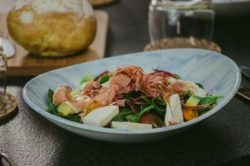 a salad in a blue bowl on a table at Central Hotel Boutique in Chihuahua