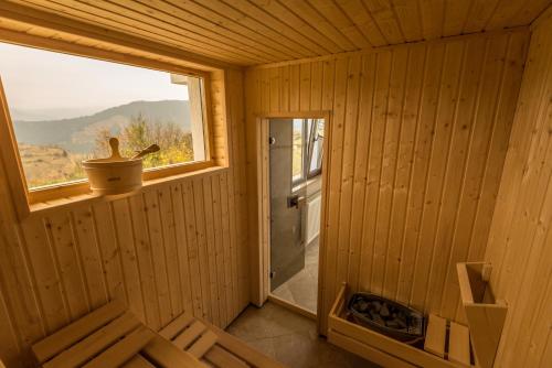 a wooden sauna with a window and a bench at Guest House Panorama in Gela