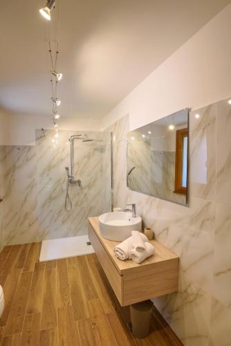 a bathroom with a sink and a mirror at Maison Balù Villa in Torri del Benaco