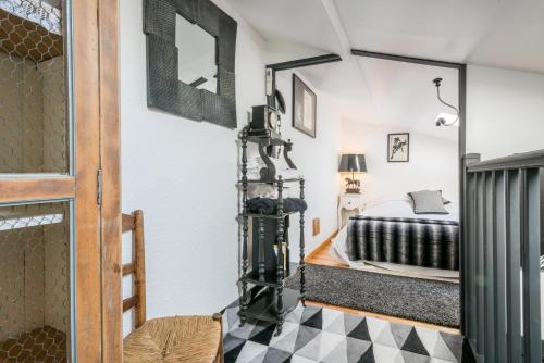 a bedroom with a bed and a mirror at Haras Picard Du Sant Le Chalet in Lasserre