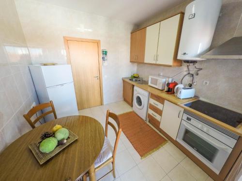 a kitchen with a wooden table and a table and a dining room at Casa do Pateo in Évora
