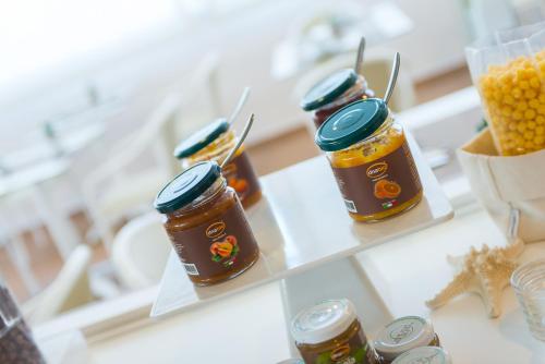 a group of jars of honey on a table at Hotel Cristallo in Riccione