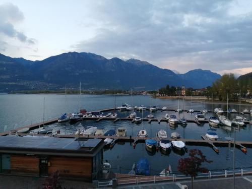 a marina with boats docked in the water with mountains at Appartamento Goen in Pisogne