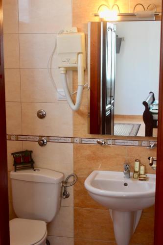 a bathroom with a sink and a toilet and a mirror at Nir Apartments Budva in Budva