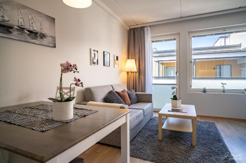 a living room with a couch and a table at Westbay Inn in Vaasa