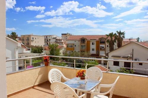 a balcony with a table and chairs and buildings at Nir Apartments Budva in Budva