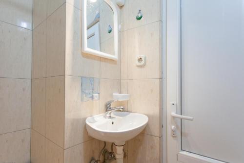 a bathroom with a sink and a mirror and a shower at Marko Apartments in Struga