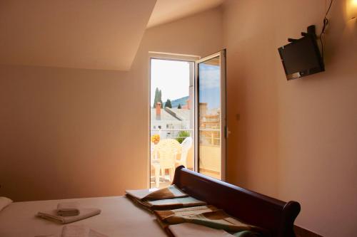 a room with a table and a window with a view at Nir Apartments Budva in Budva