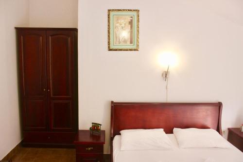 a bedroom with a bed and a picture on the wall at Nir Apartments Budva in Budva